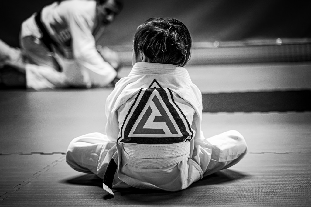 child in gi with Living Art Brazilian Jiu Jitsu logo